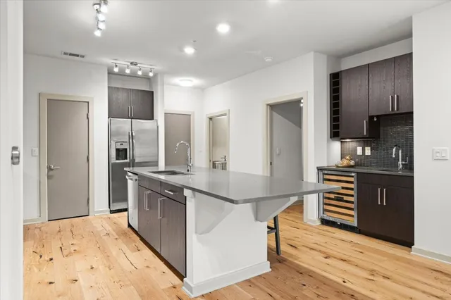 a kitchen with sink and view living room