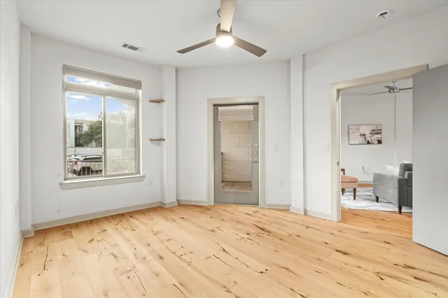 a bathroom with a sink a toilet a mirror and shower