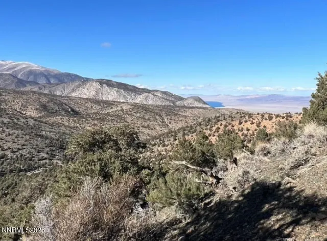 a view of a large mountain with mountains in the background