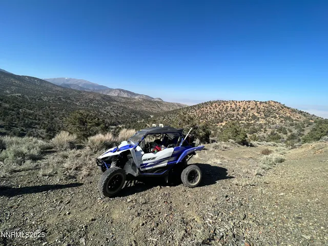 a view of outdoor space with deck and mountain view