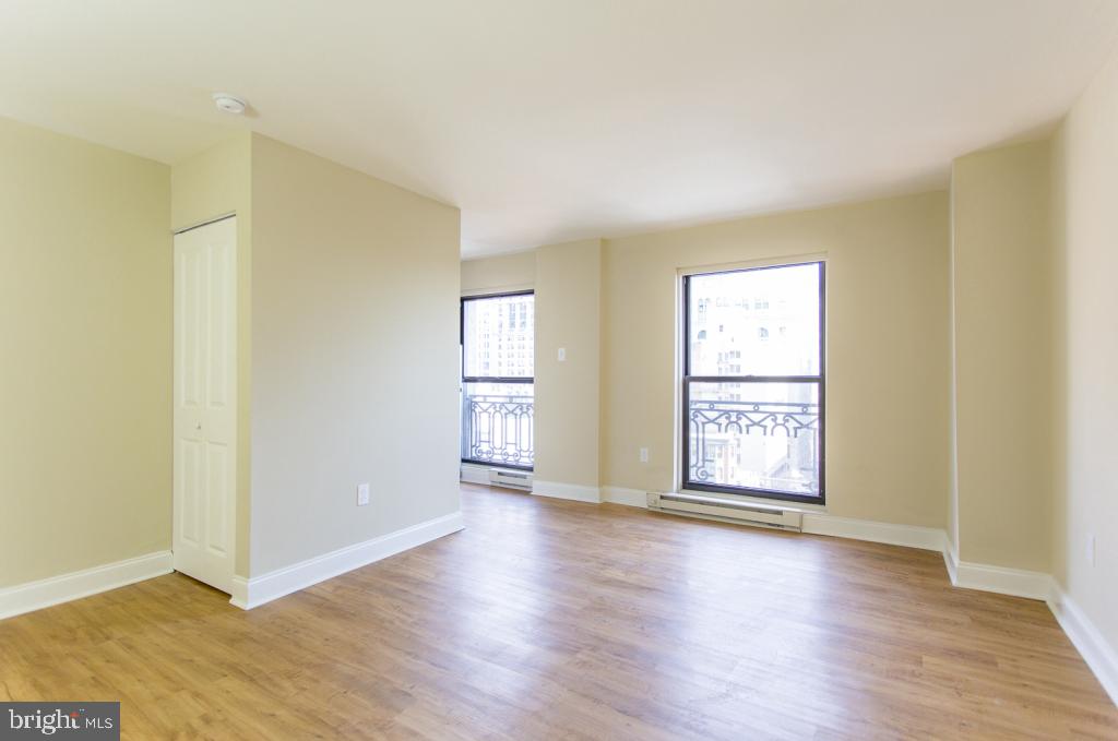 201 South 13th Street, Unit 1006 Philadelphia, PA 19107 - Photo 11 of 23 an empty room with wooden floor and windows