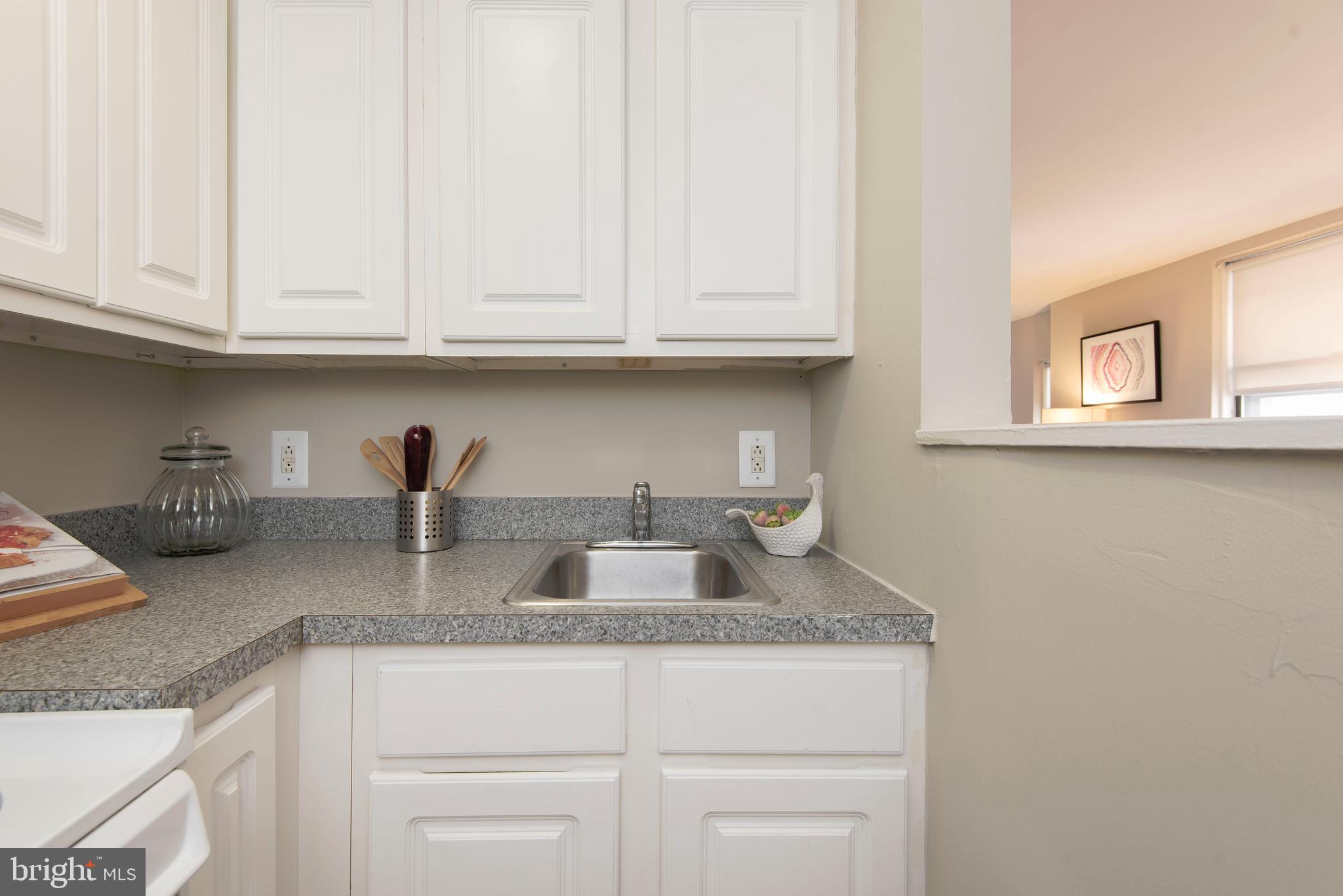 201 South 13th Street, Unit 1006 Philadelphia, PA 19107 - Photo 7 of 23 a kitchen with granite countertop white cabinets and a sink