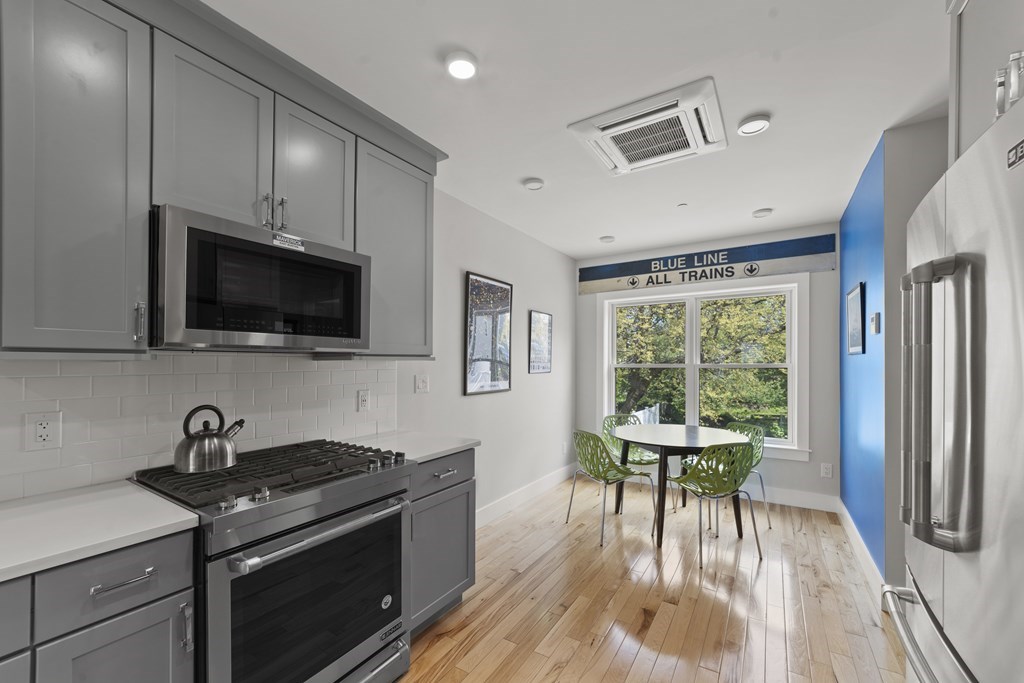 a kitchen with stainless steel appliances a stove a sink and a microwave