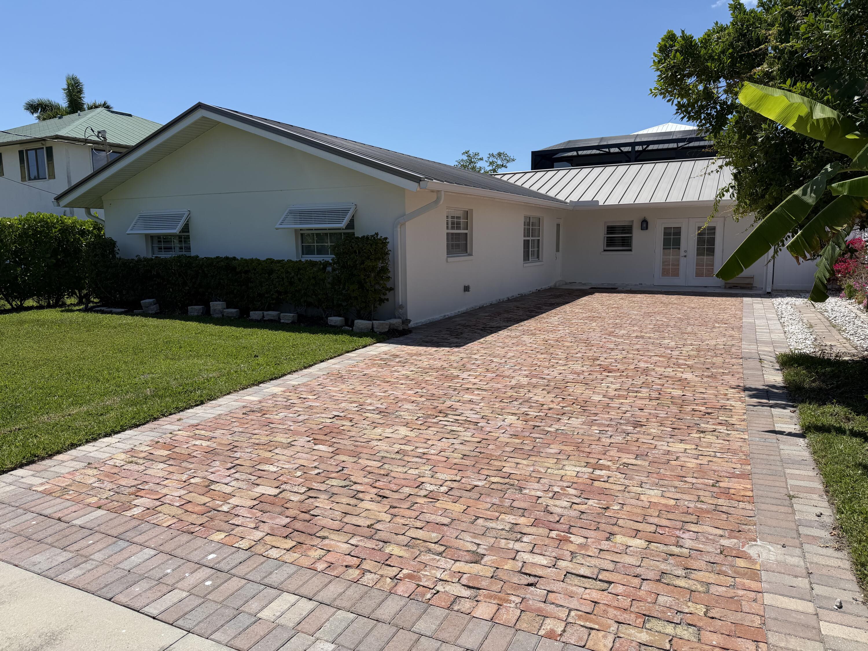 112 Capri Boulevard Naples, FL 34113 - Photo 2 of 29 a front view of a house with a yard and a garage
