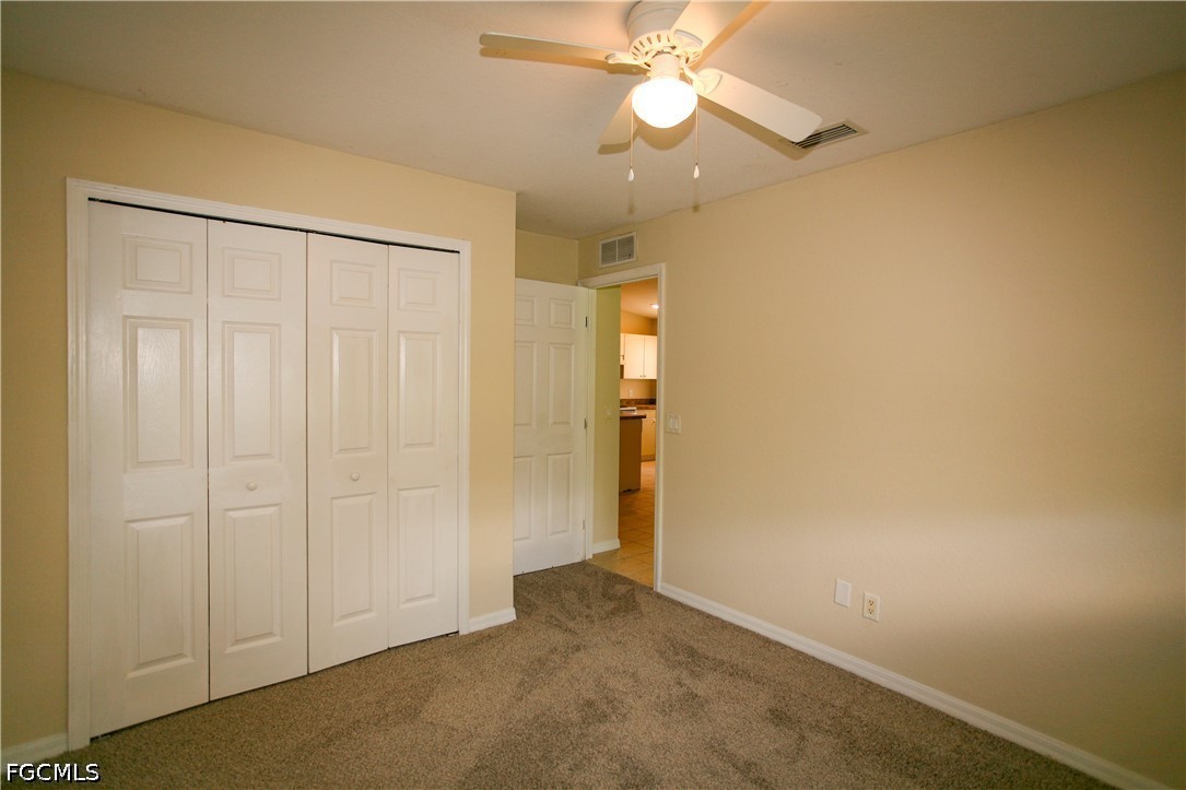 4614 25th Street Southwest Lehigh Acres, FL 33973 - Photo 11 of 15 an empty room with a ceiling fan and a window