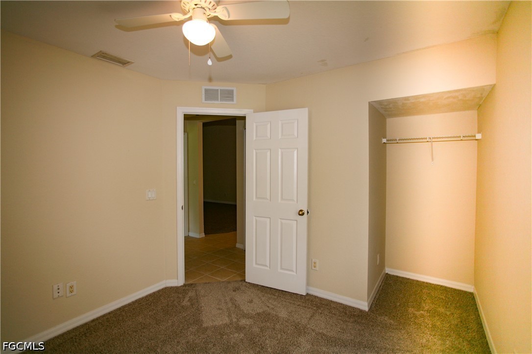 4614 25th Street Southwest Lehigh Acres, FL 33973 - Photo 13 of 15 a view of a livingroom with a chandelier fan