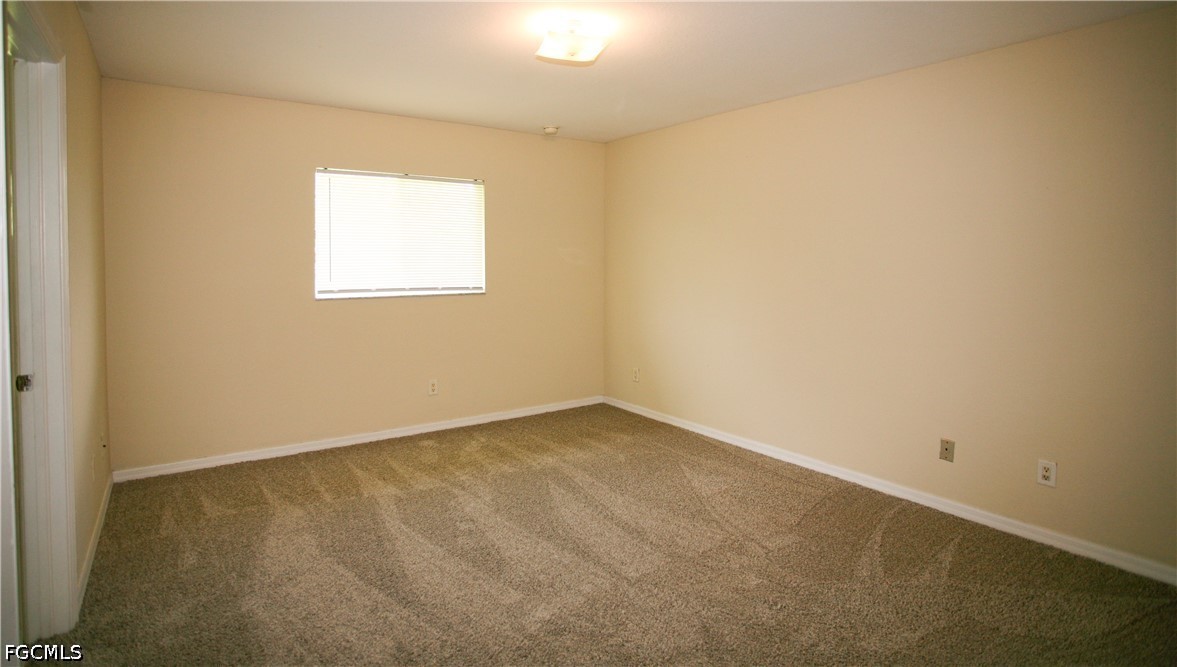 4614 25th Street Southwest Lehigh Acres, FL 33973 - Photo 6 of 15 an empty room with a window