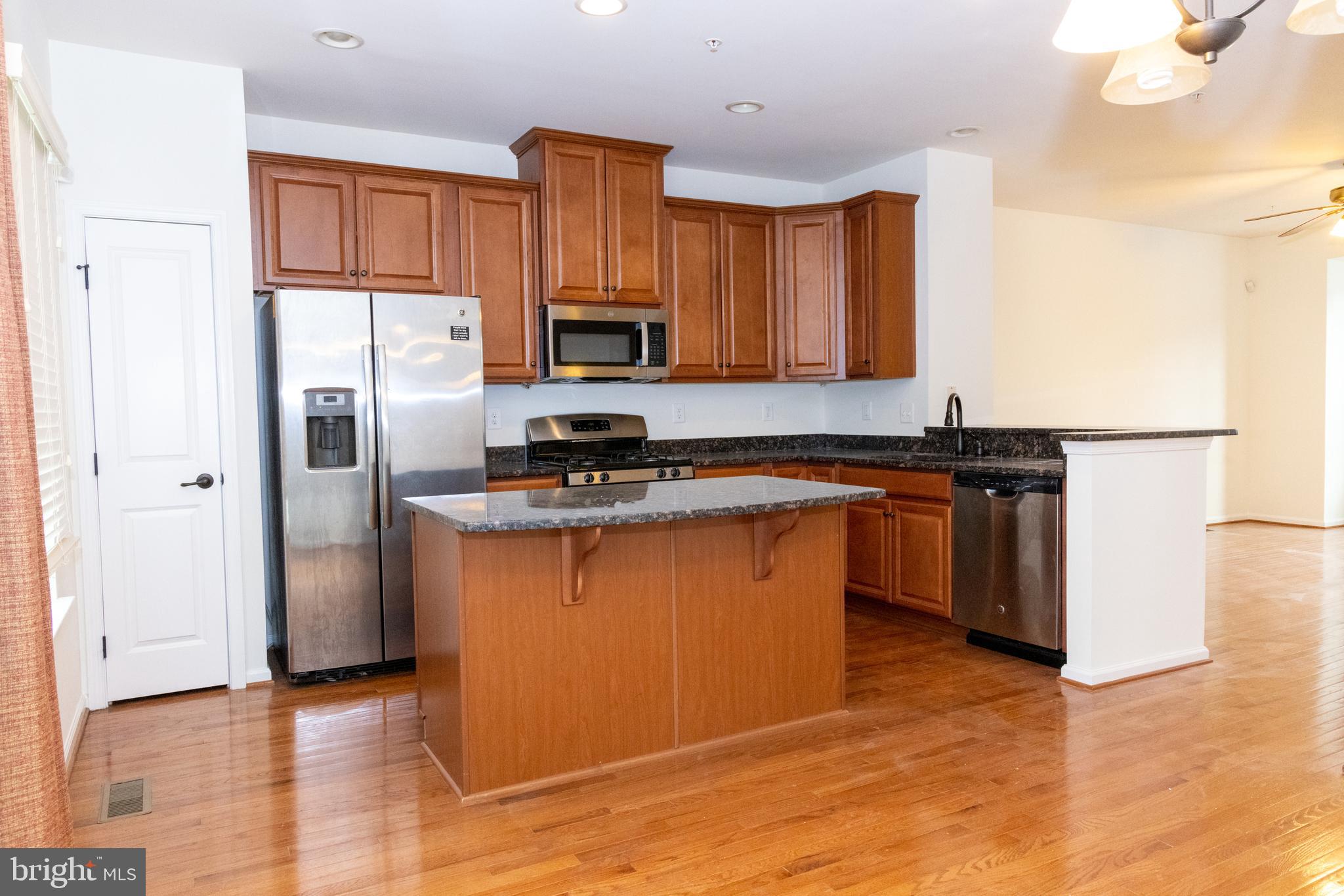 7317 Summit Rock Road Elkridge, MD 21075 - Photo 12 of 36 a kitchen with stainless steel appliances a refrigerator stove microwave and sink