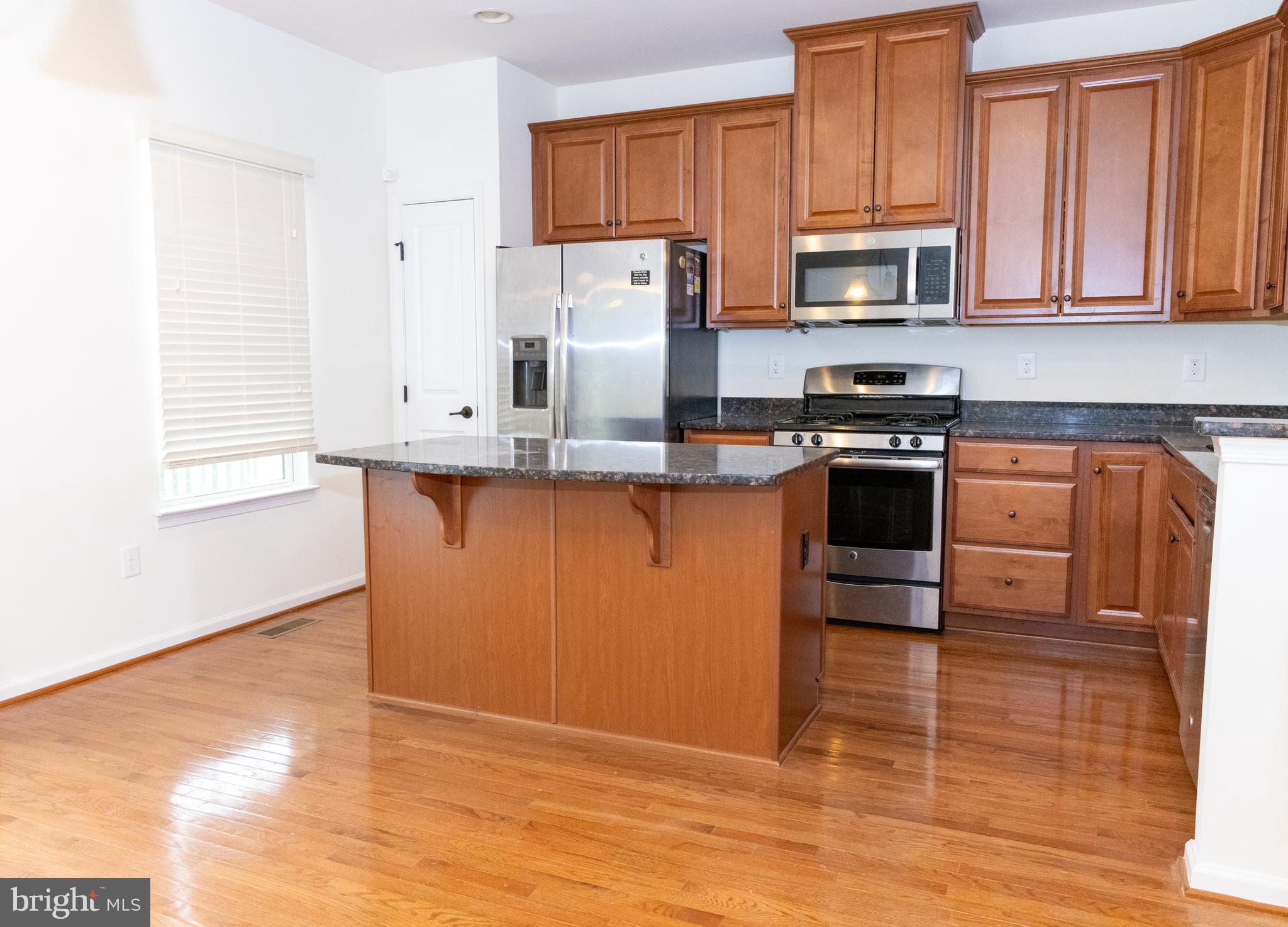 7317 Summit Rock Road Elkridge, MD 21075 - Photo 14 of 36 a kitchen with stainless steel appliances granite countertop a stove a sink dishwasher and a refrigerator