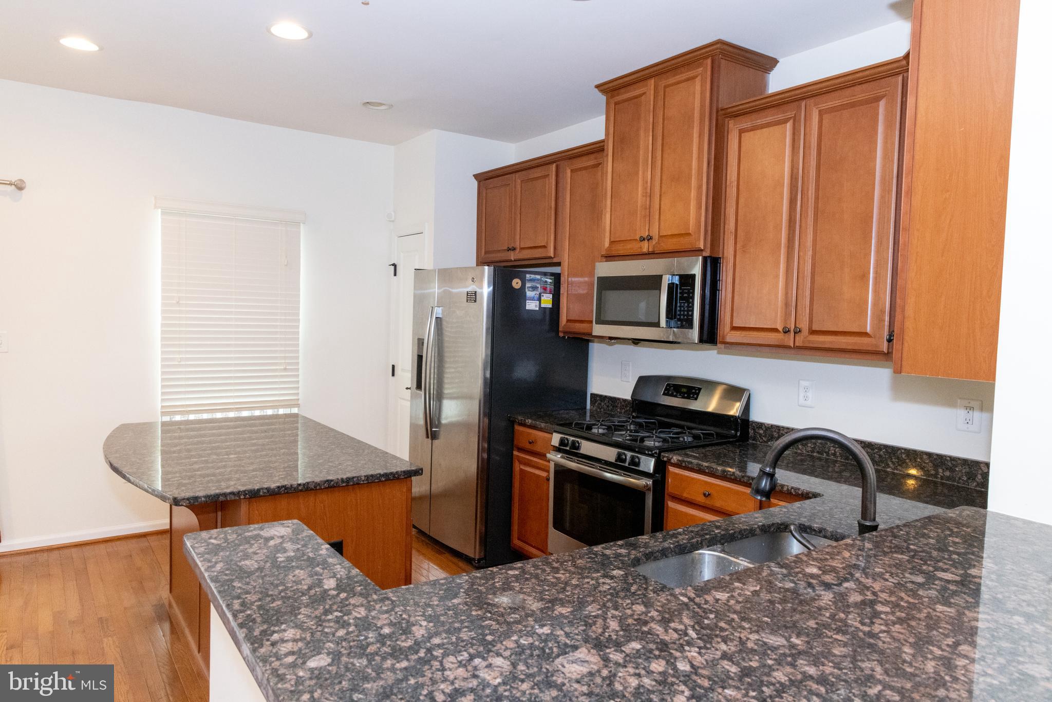 7317 Summit Rock Road Elkridge, MD 21075 - Photo 15 of 36 a kitchen with stainless steel appliances granite countertop a granite counter tops and a refrigerator