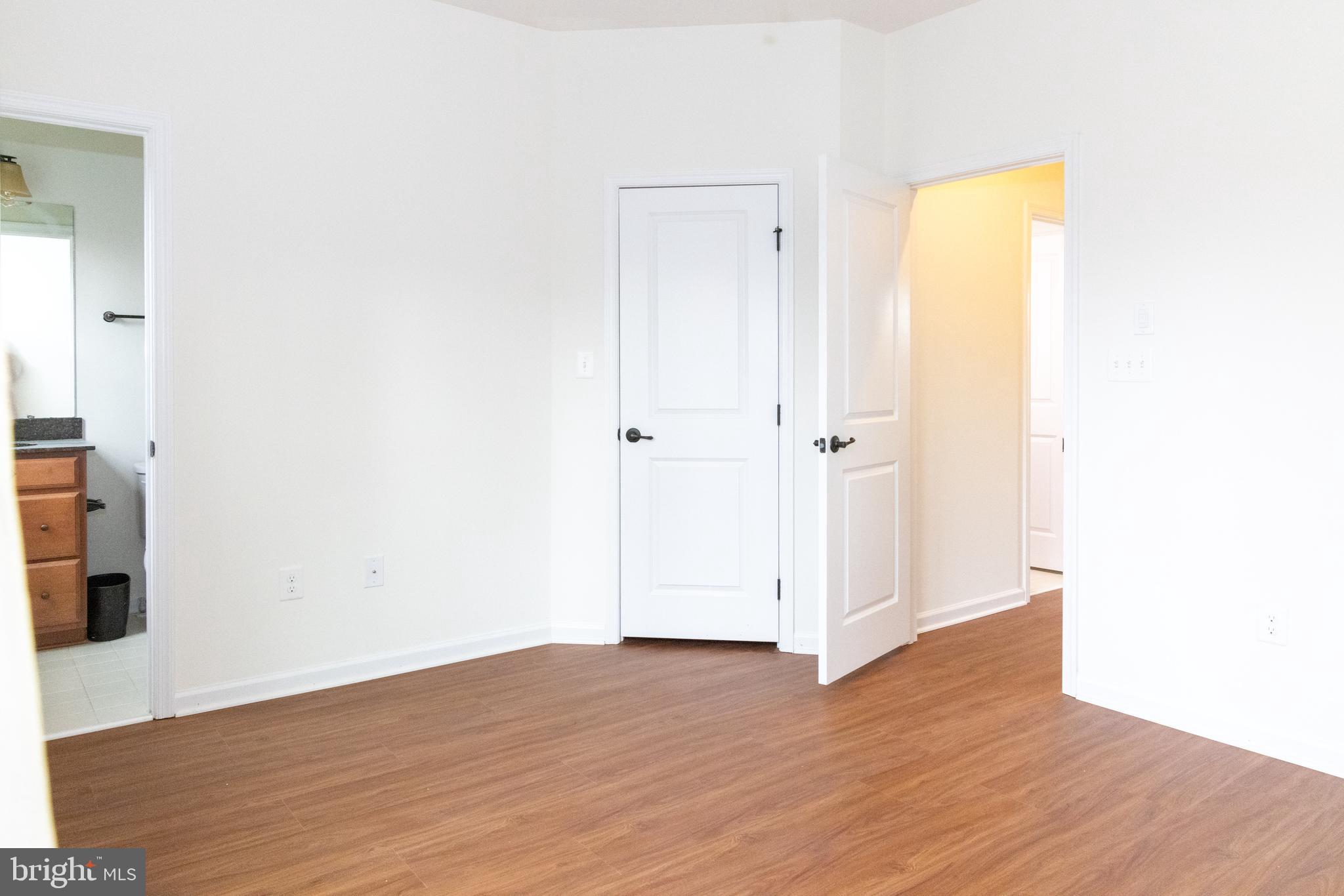 7317 Summit Rock Road Elkridge, MD 21075 - Photo 21 of 36 an empty room with wooden floor and a window