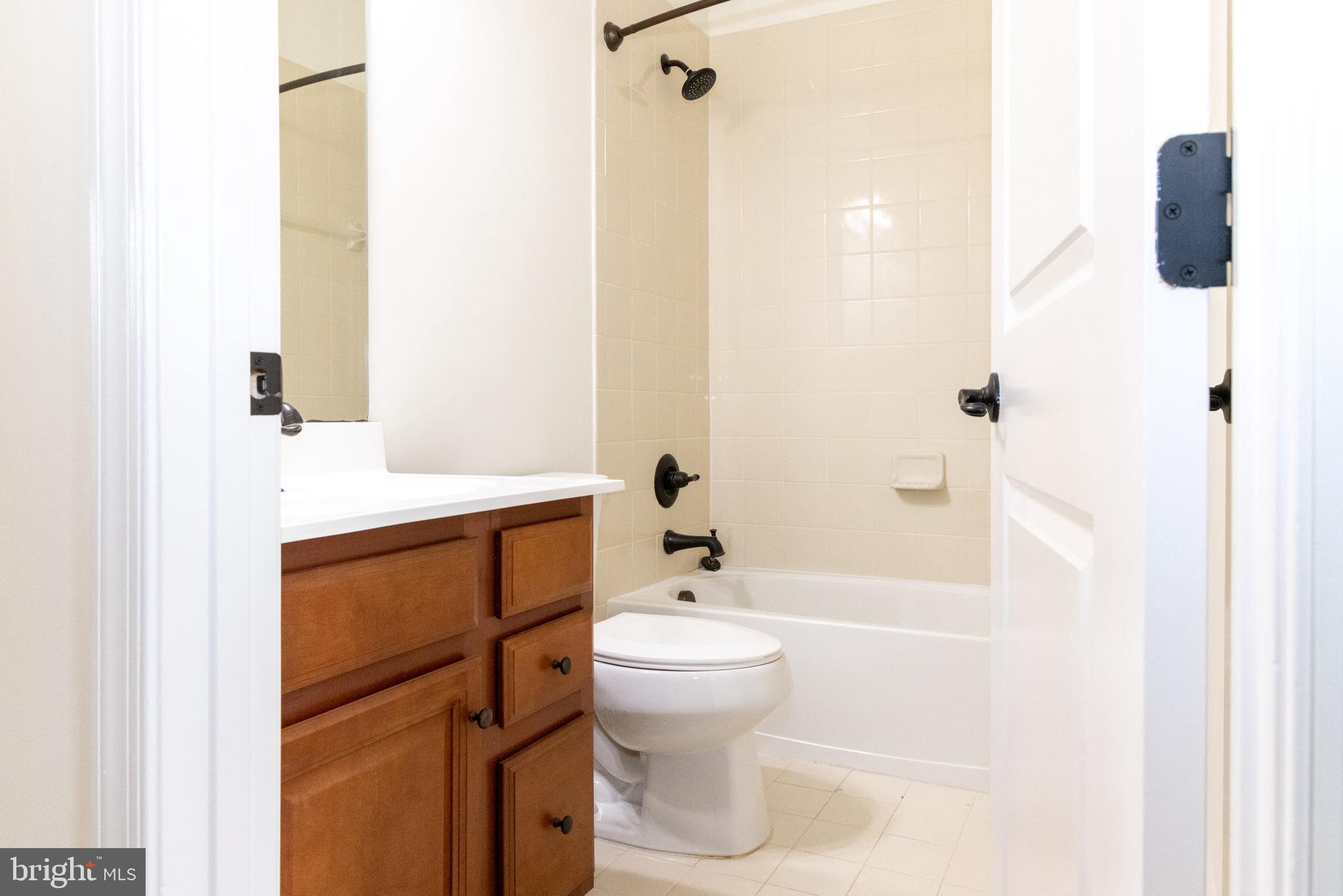7317 Summit Rock Road Elkridge, MD 21075 - Photo 22 of 36 a bathroom with a sink a toilet and shower