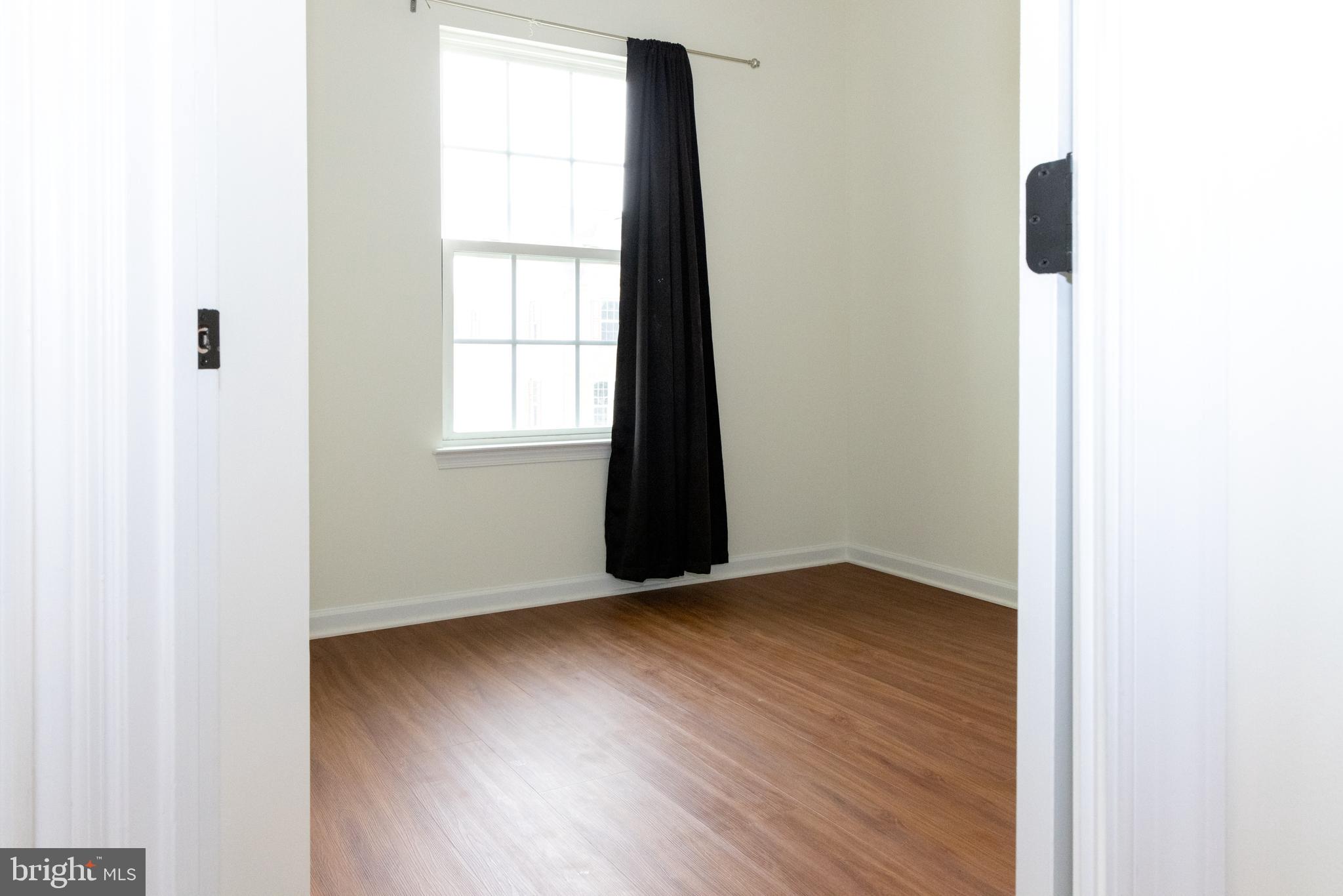 7317 Summit Rock Road Elkridge, MD 21075 - Photo 23 of 36 an empty room with wooden floor and windows