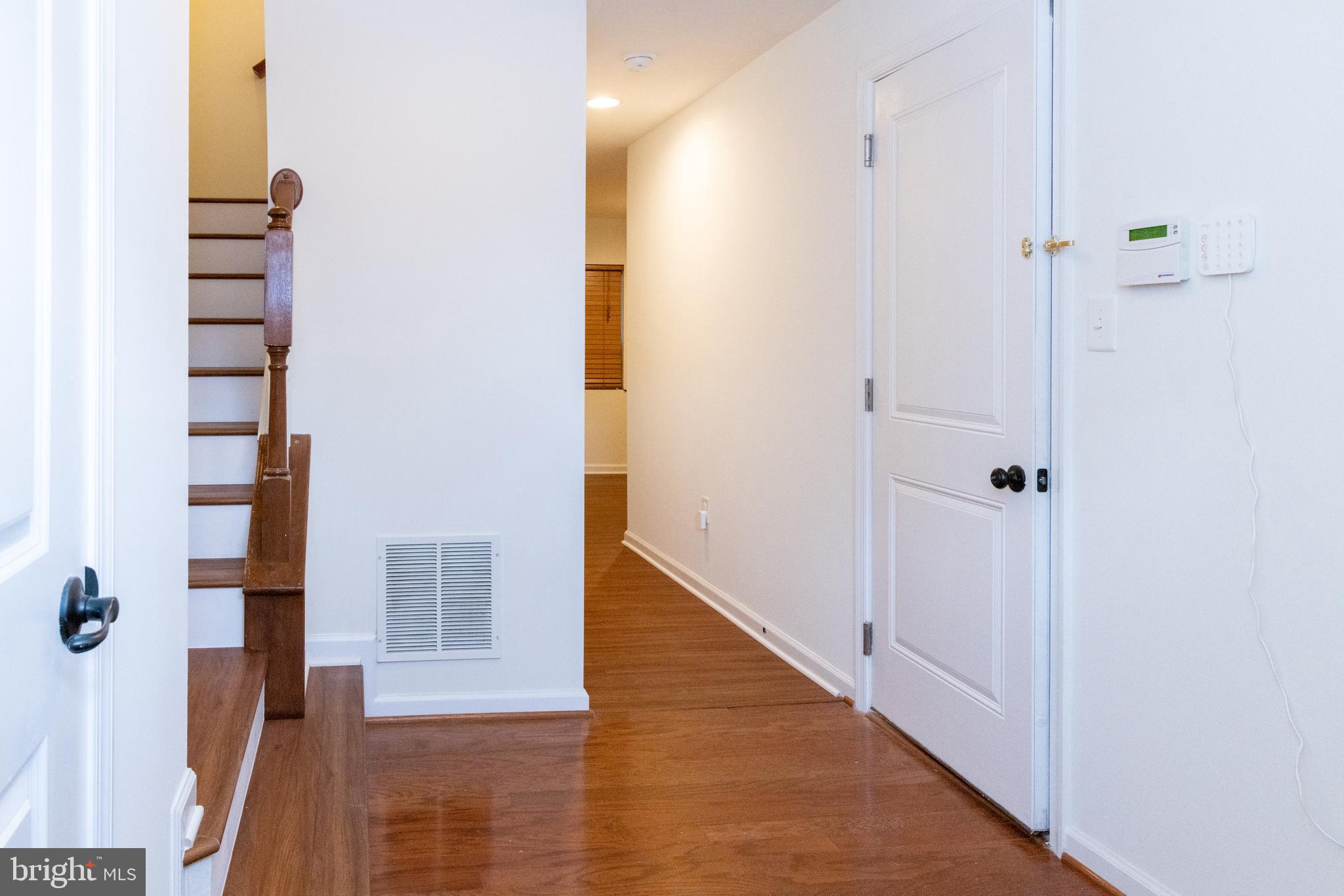7317 Summit Rock Road Elkridge, MD 21075 - Photo 3 of 36 a view of a hallway with wooden floor and entryway
