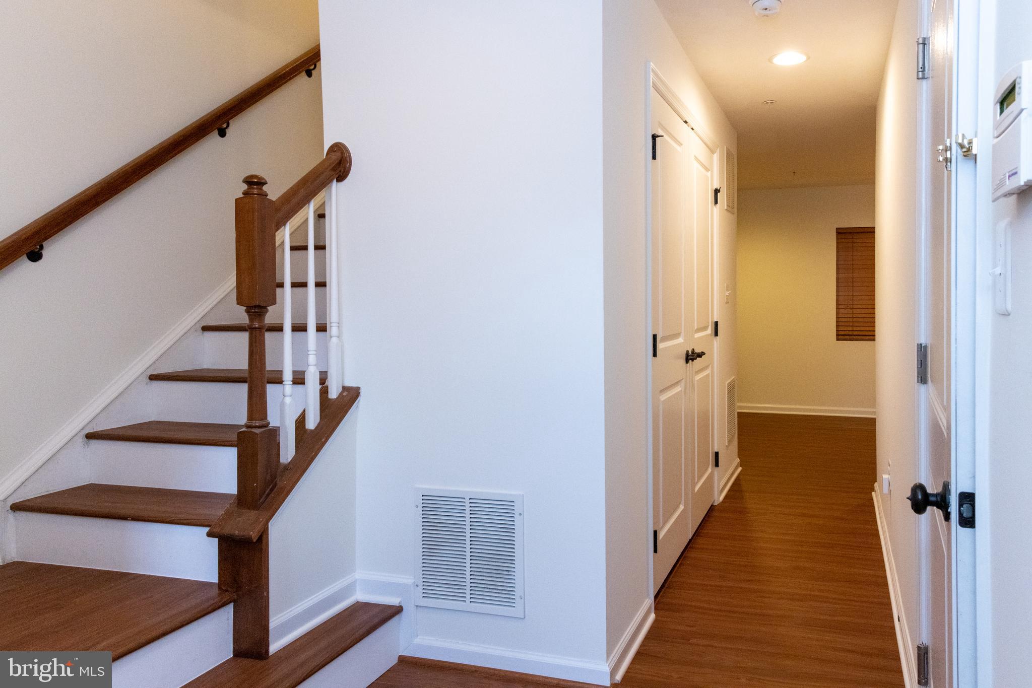 7317 Summit Rock Road Elkridge, MD 21075 - Photo 9 of 36 a view of a hallway with wooden floor and staircase