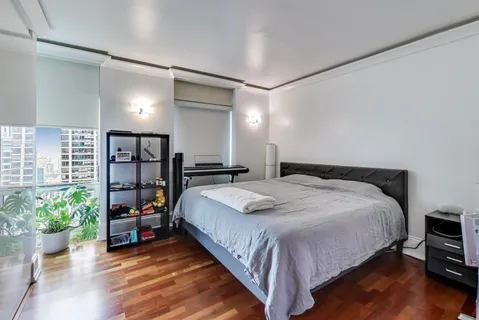 a view of a bedroom with wooden floor