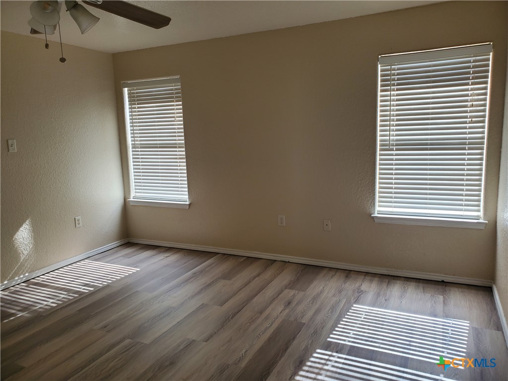 3413 Rob Roy Street Seguin, TX 78155 - Photo 11 of 13 a view of an empty room with wooden floor and a window