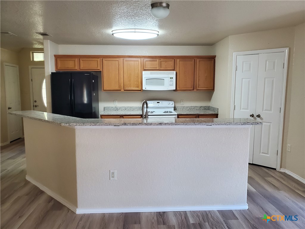 3413 Rob Roy Street Seguin, TX 78155 - Photo 5 of 13 a kitchen with stainless steel appliances granite countertop a refrigerator and a stove