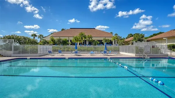 an aerial view of a residential houses with outdoor space and swimming pool