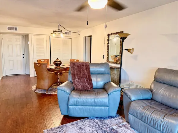a view of a dining room with furniture and wooden floor