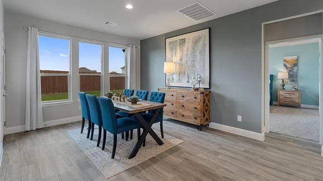 a dining room with furniture and wooden floor