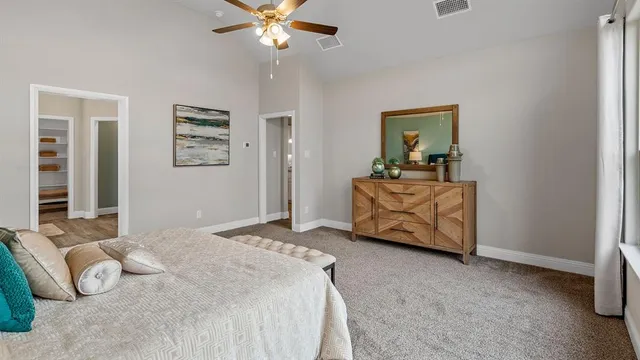 a bedroom with a bed and a large window