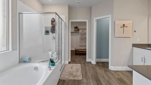 a spacious bedroom with a bed and a large window