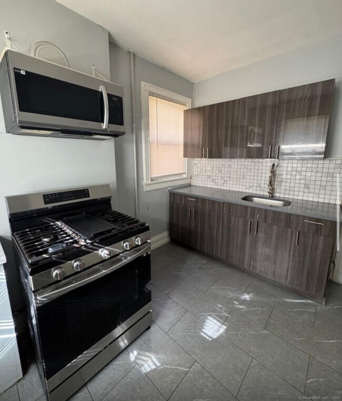 a kitchen with a stove and a microwave