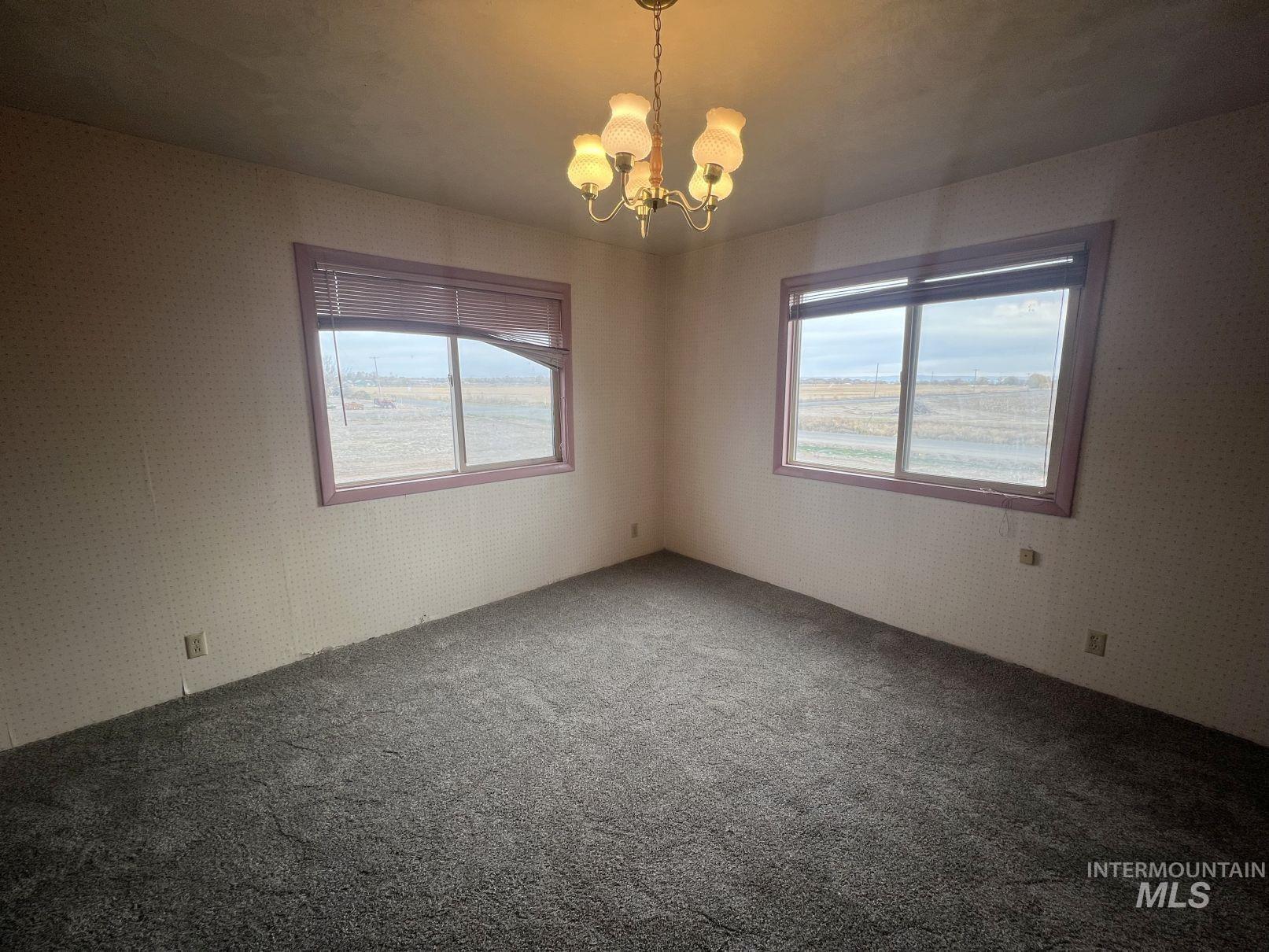 156 West 100 North Jerome, ID 83338 - Photo 10 of 15 Unfurnished room featuring a chandelier and carpet flooring