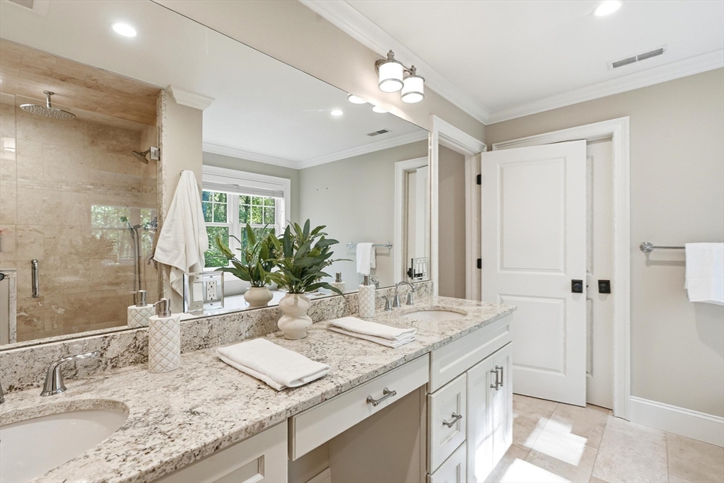 6 Flintlock Road Lexington, MA 02420 - Photo 23 of 39 a bathroom with a granite countertop sink and a mirror