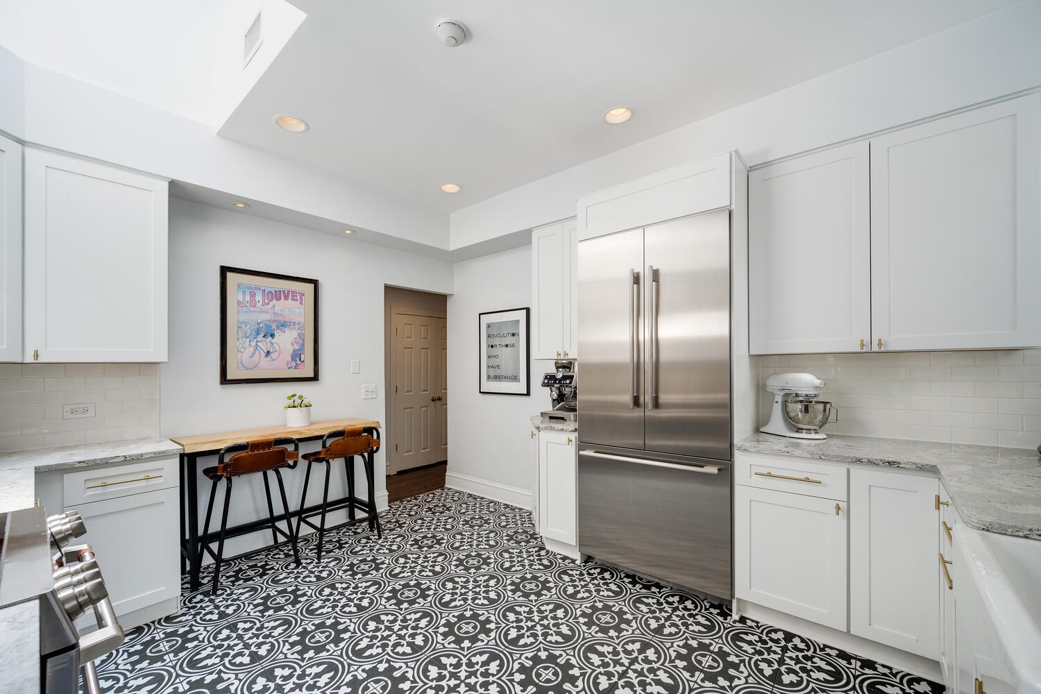 21 East Elm Street, Unit 3D Chicago, IL 60611 - Photo 13 of 27 a kitchen with stainless steel appliances a refrigerator and a stove top oven