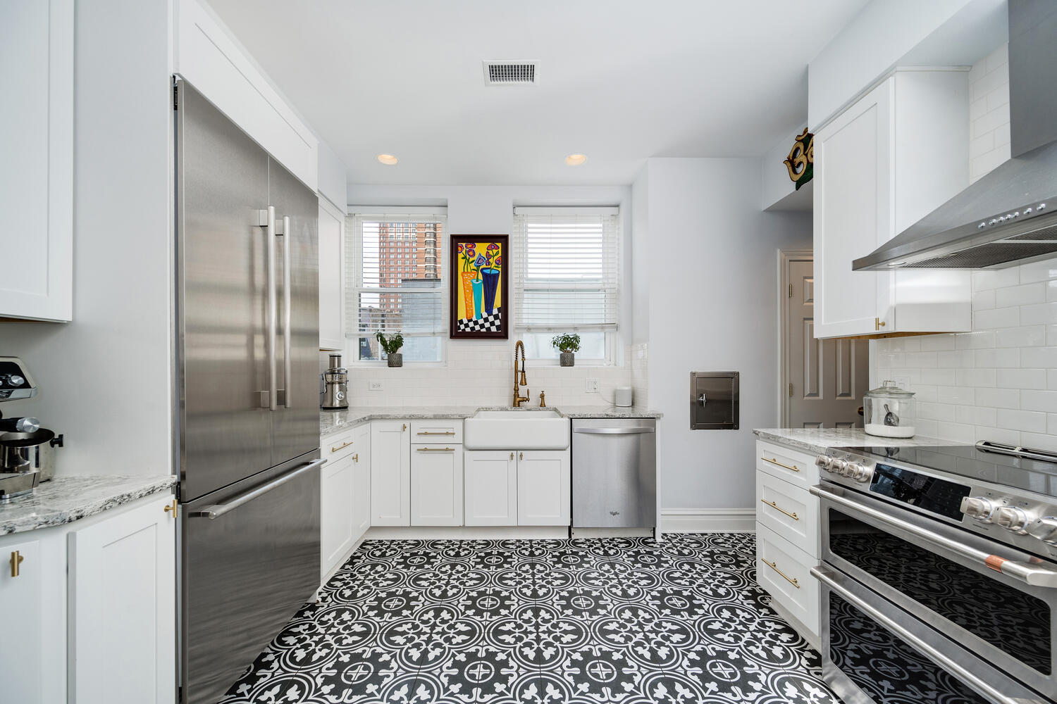 21 East Elm Street, Unit 3D Chicago, IL 60611 - Photo 15 of 27 a kitchen with white cabinets a sink stove and refrigerator