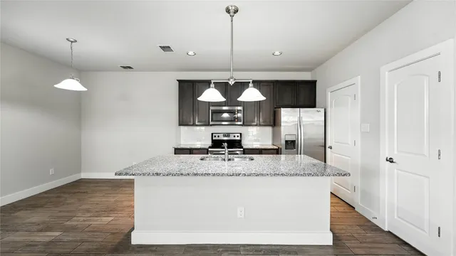 a large kitchen with a table and chairs