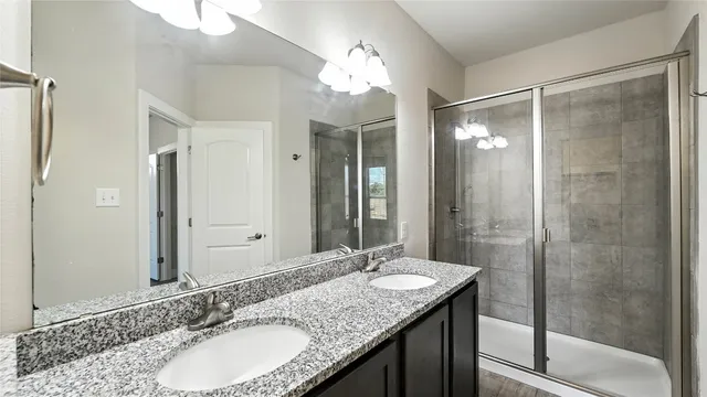 a bathroom with a glass shower door
