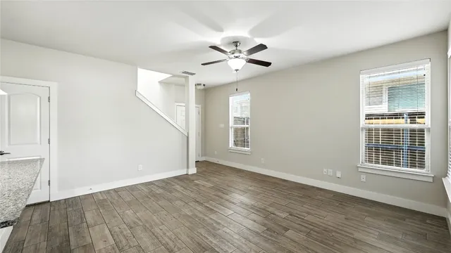 a living room with stainless steel appliances kitchen island furniture and a large window