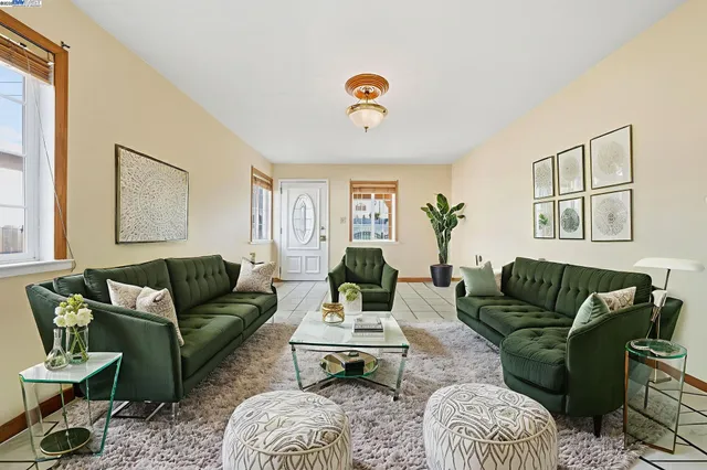 a bedroom with a large bed and a potted plant