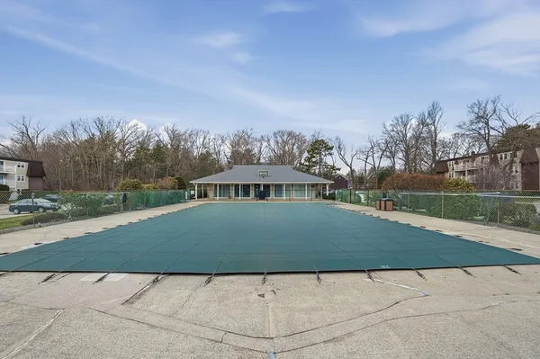 a view of swimming pool in front of house