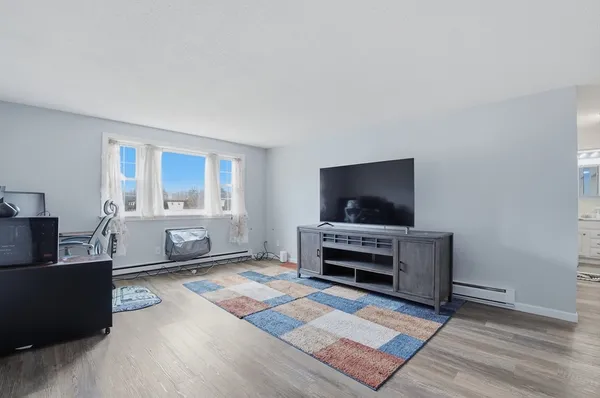 a living room with furniture and flat screen tv