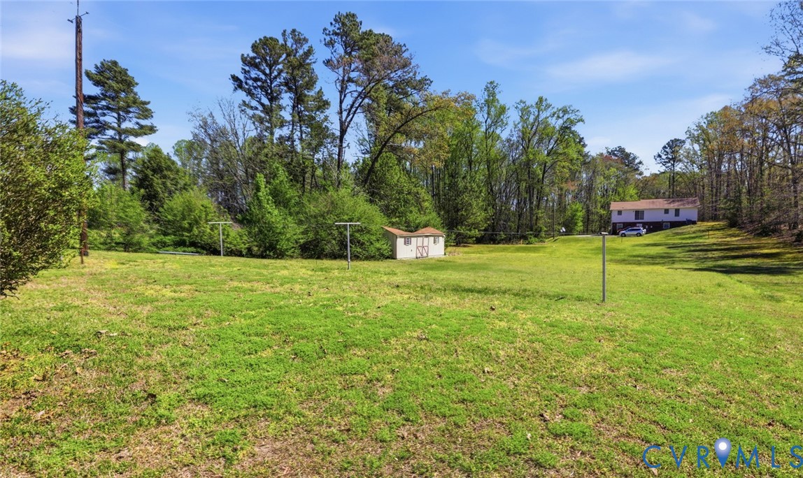 19353 Boulwares Road Ruther Glen, VA 22546 - Photo 62 of 62 View of green lawn featuring a storage shed and vi
