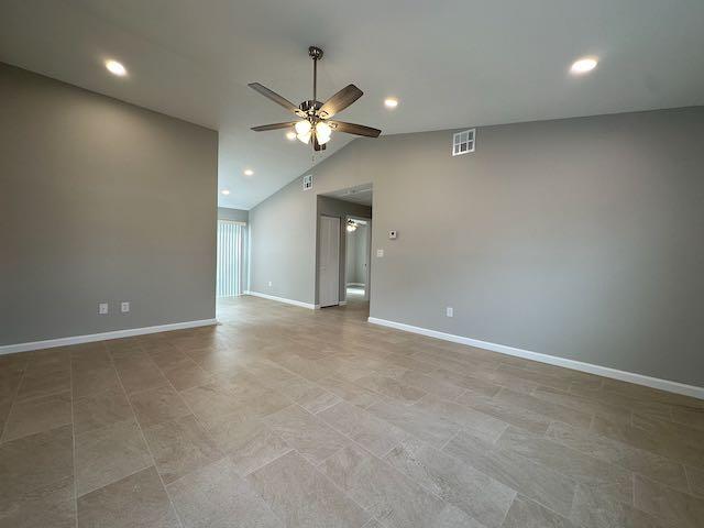 3166 Southeast Garden Street, Unit 3166 Stuart, FL 34997 - Photo 2 of 10 an empty room with a ceiling fan and a window