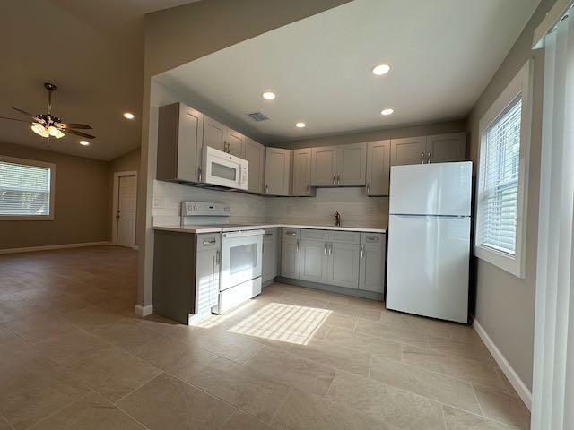 3166 Southeast Garden Street, Unit 3166 Stuart, FL 34997 - Photo 5 of 10 a kitchen with stainless steel appliances granite countertop a refrigerator a sink and a stove