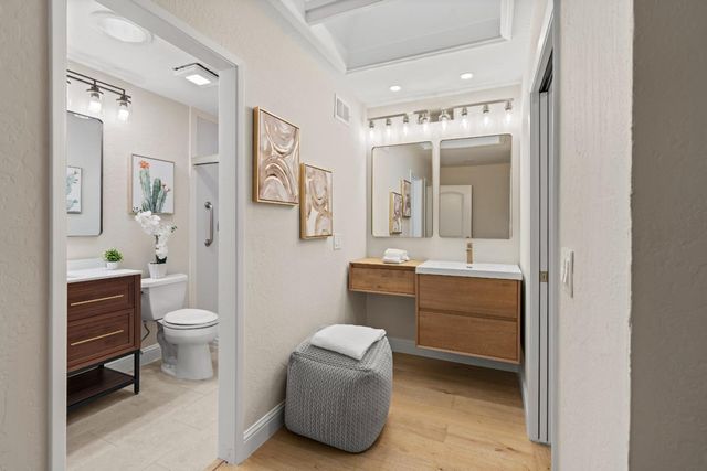 a bathroom with a toilet a sink and mirror