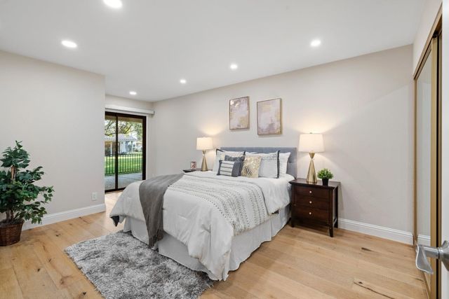 a bed room with a bed and a potted plant