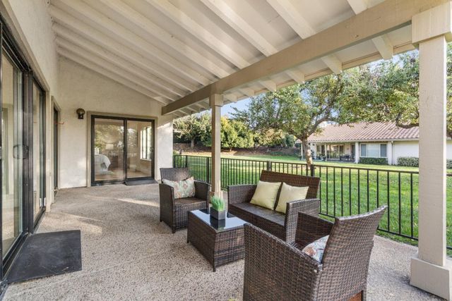 a balcony with furniture and a garden