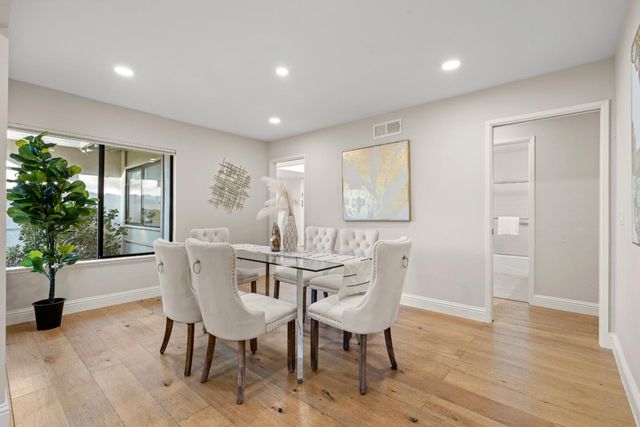 a view of a dining room with furniture window and wooden floor