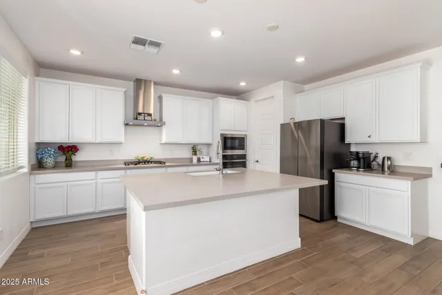 a kitchen with stainless steel appliances granite countertop a sink stove and cabinets