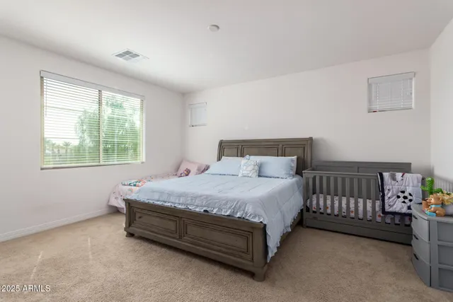 a bathroom with a double vanity sink a mirror and a bathtub