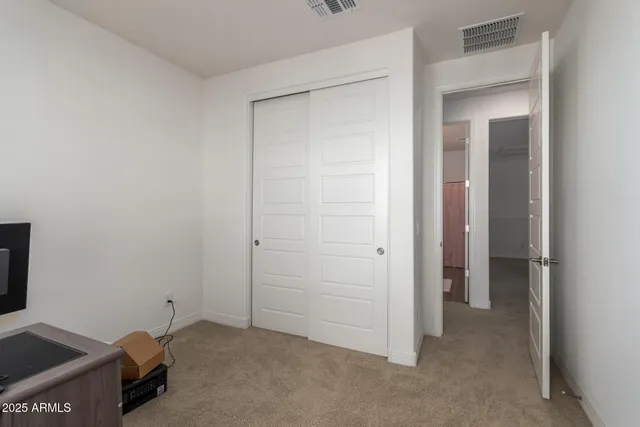 a view of a white house in front of a big yard