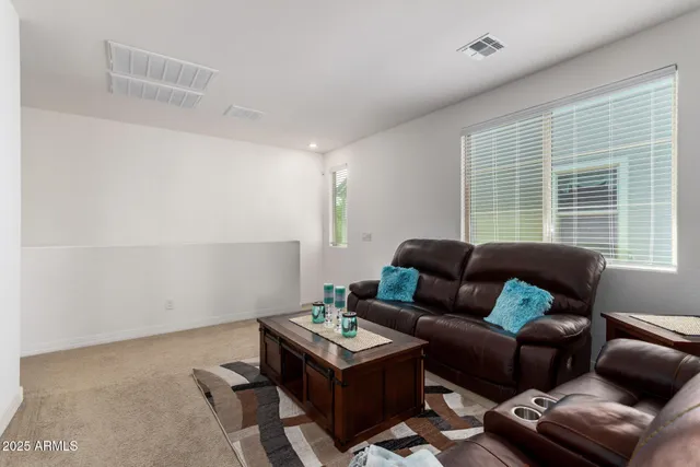 a view of a backyard with plants and wooden fence