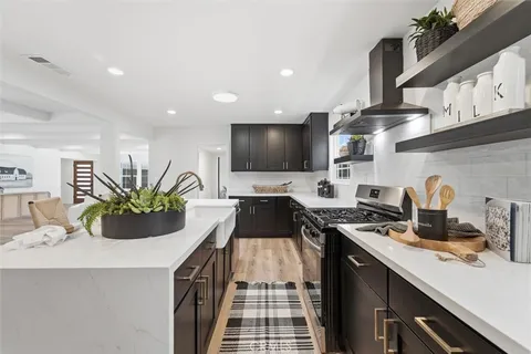 a kitchen with a sink a counter and cabinets